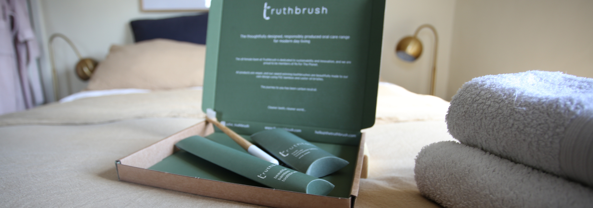 Susbcription box of truthbrush toothbrushes on bed in boho bedroom